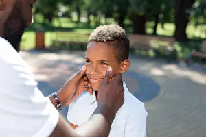Optimistic Prints: Nice caring father touching his sons cheeks