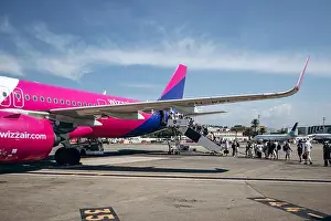 Passenger Prints: Nice, France - August 5, 2024: Wizz Air aircraft boarding passengers at Nice airport