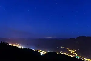 Milky Way Prints: Night intermountain city of Smolyan with bright evening electric lights under a clear sky with bright small stars