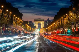 Blurred Motion Prints: Night scence illuminations traffic street of the Impressive Arc de Triomphe Paris along the famous tree lined Avenue