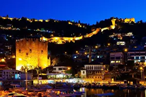 Lighted Prints: Night view of Alanya cityscape from harbor pier overlooking Red Tower and Castle
