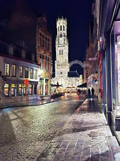 European Culture Prints: Night view of Bruges cobblestone street leading to the Belfry of Bruges