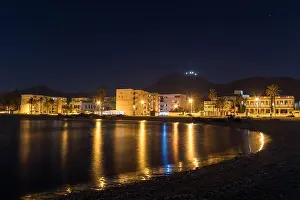 City Lights Prints: A Night View of Houses and Street Lights by the Sea in Tunis