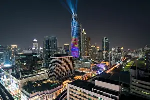 Night view with skyscraper in business district in Bangkok Thailand. Light show at Magnolias Ratchaprasong in Bangkok, Thailand