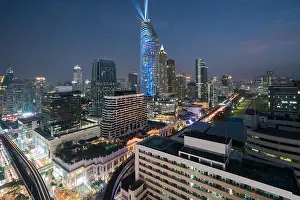 Night view with skyscraper in business district in Bangkok Thailand. Light show at Magnolias Ratchaprasong in Bangkok, Thailand