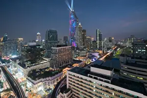 Night view with skyscraper in business district in Bangkok Thailand. Light show at Magnolias Ratchaprasong in Bangkok, Thailand