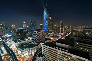 Night view with skyscraper in business district in Bangkok Thailand. Light show at Magnolias Ratchaprasong in Bangkok, Thailand