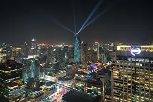 Night view with skyscraper in business district in Bangkok Thailand. Light show at Magnolias Ratchaprasong in Bangkok, Thailand