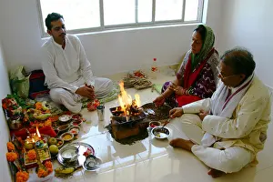 Sadhu Prints: North Indian Hindu couple husband wife performing home inauguration worship Model release number 542