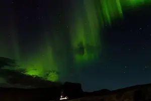Northern Lights Prints: Northern lights shine above the church in VIk, Iceland