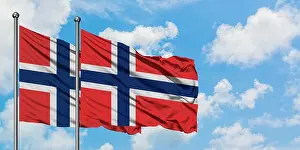 Citizenship Prints: Norway and Bouvet Islands flag waving in the wind against white cloudy blue sky together