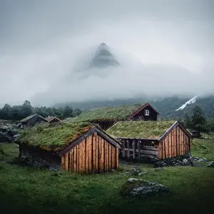 Norwegian old wooden fishing houses with grass roofs in Innerdalen - Norway's most beautiful mountains valley, near Innerdalsvatna lake