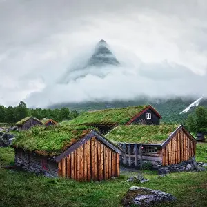 Norwegian old wooden fishing houses with grass roofs in Innerdalen - Norway's most beautiful mountains valley, near Innerdalsvatna lake
