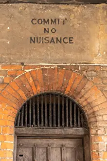 Buckinghamshire Prints: Notice reading 'commit no nuisance' above the old town lock-up inside the historic 17th century market hall