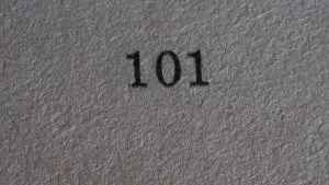 Numeral Prints: The number 101 printed on a piece of paper. Paper texture