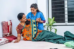 Wake Up Prints: Nurse helping sick senior woman to get up from bed during day care - concept of professional occupation