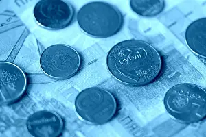Toned Prints: Obsolete Belarusian banknotes and coins close-up, blue color toned