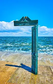 Sunbathing Prints: ODESSA, UKRAINE - JUNE 18, 2021: The House of the sun door bronze sculpture by Mikhail Reva