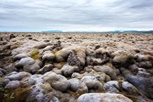 Lava Field Prints: Offbeat Iceland landscape with lava field covered with brown moss Eldhraun from volcano eruption and cloudy sky