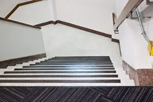 Lobby Prints: Empty office staircase vanishing downstairs