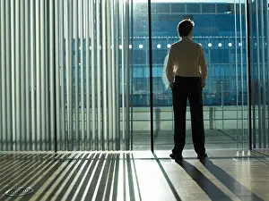 Reflecting Prints: Office worker looking out of the window