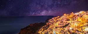 Oia village at night, Santorini island. Famous travel landscape, luxury vacation destination scenic. Beautiful view of fabulous picturesque village