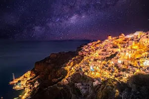 Oia village at night, Santorini island. Famous travel landscape, luxury vacation destination scenic. Beautiful view of fabulous picturesque village
