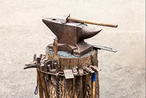 Hammer Prints: Old anvil with blacksmith tools at the outdoors