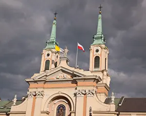 Old Palace Prints: Old church with polish flags in Warsaw Poland