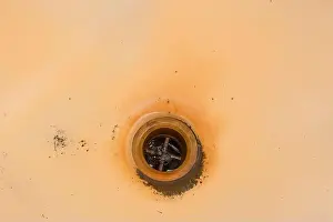 Sanitary Prints: Old dirty bath with rust and a hole for drain fluzing impure water into sewer pipes