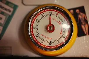 Timer Prints: An old fashioned hour timer refrigerator magnet hanging on a refrigerator