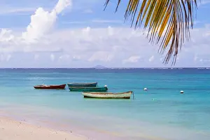 Blue Boat Prints: old fisherman boats moored near sandy beach on Mauritius island