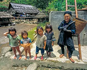 Poses Prints: Old grandmother and happy kids poses in the yard, a village outside Sapa, Vietnam