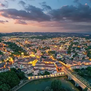 Old italian city Umbertide near Tevere river with cloudy sunset light. Aerial view from above