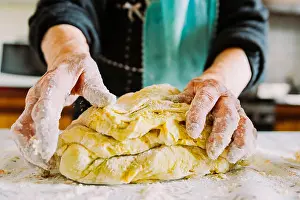 Woman Work Prints: old italian gradma hands making fresh homemade pasta in the kitchen with flour, a close up
