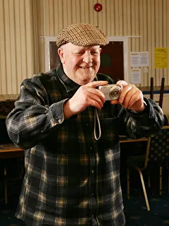Mans Prints: Old people men using new technology digital camera in local working mans club pub