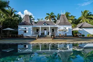 Inflatable Prints: old plantation house with swimming pool and beach chairs by the ocean