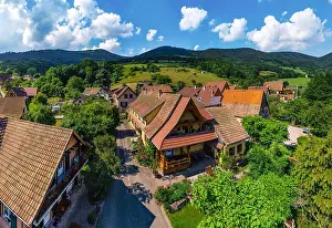 Old but renovated village house in countryside aerial view, Alsace, France