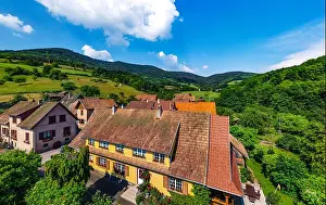 Old but renovated village house in countryside aerial view, Alsace, France