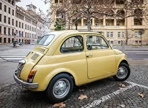 Northern Italy Prints: old retro yellow classic Fiat 500 car on street of Bolzano city in South Tyrol