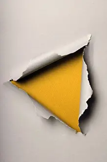 Bent Prints: Old ripped paper forming triangle over yellow background