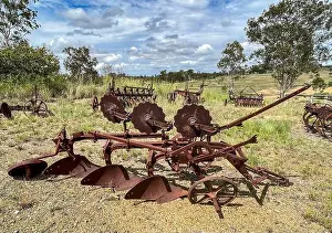 Paddock Prints: Old rusty 3 point furrow mouldboard plough in the field of a farm
