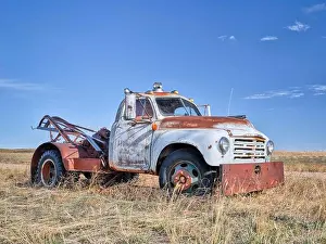 Backcountry Prints: old rusty towing truck on a prairie, early spring scenery in Colorado
