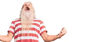 Senior Man Prints: Old senior man with grey hair and long beard wearing striped tshirt angry and mad screaming frustrated and furious