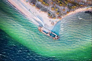 Old shipwreck reinforced concrete barge abandoned stand on beach on the coast of Black sea in Ukraine