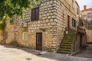 Tarmac Prints: An old stone house in the historic centre of Kastel Kambelovac in Kastela on the mainland of Croatia