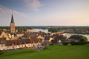 Old town of La-Charité-sur-Loire, stone bridge over the Loire river, Church and former monastery Notre Dame in the background, T