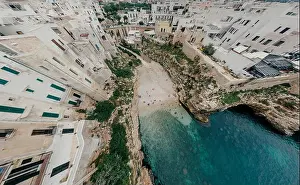 Alberobello Prints: Old white city near blue the Sea Polignano Apulia Coastline blue in Italy Drone 360 vr