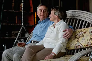 Porch Prints: Older Man and Woman Sitting on a Porch Swing and Enjoying each Others Company