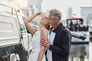 Casual Attire Prints: Older man and young woman at a marina next to a yacht